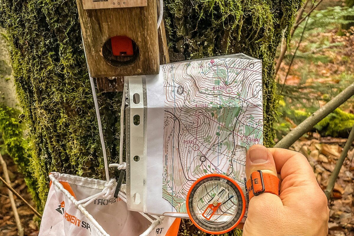 Suunnistaja metsäpolulla kompassi kädessä